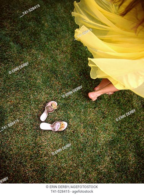 A woman spinning in a vintage yellow dress with her mother's vintage shoes left behind