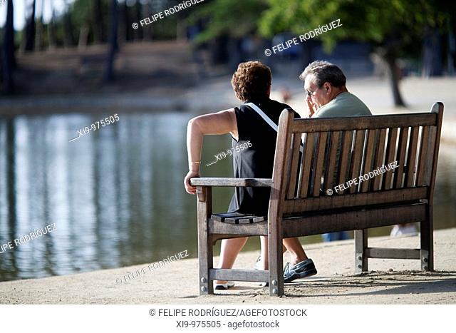 Senior couple sitting by the sea, Conleau island, town of Vannes, departament of Morbihan, region of Brittany, France