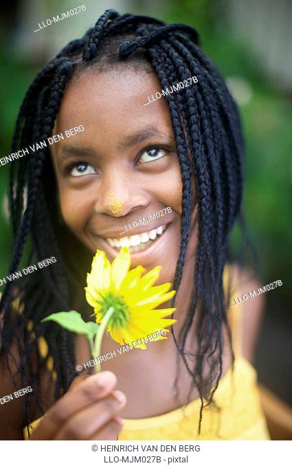 Woman with sun flower, Pietermaritzburg, KwaZulu-Natal Province, South Africa