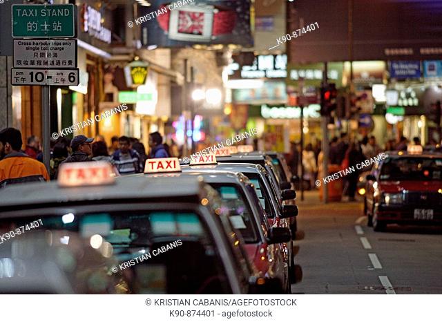 The typical red taxis queueing up idle at a taxi stand in Wanchai (Wan Chai) and waiting for customer, Hong Kong Island, Hong Kong, China, Southeast Asia