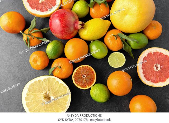 close up of citrus fruits on stone table