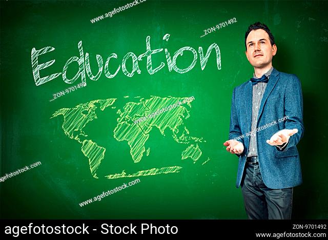 Education with a male teacher and a chalkboard with a world map