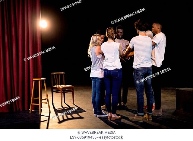 Actors team forming their hands stacked