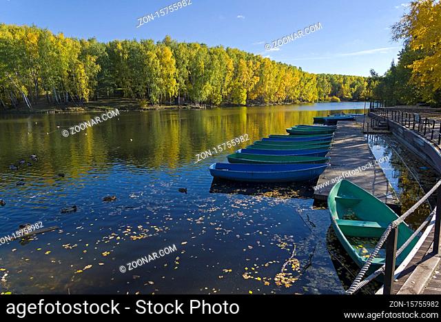 Boat station closed at the end of the season. Pond in the landscape reserve Teply Stan, Moscow, Russia. Sunny day in October