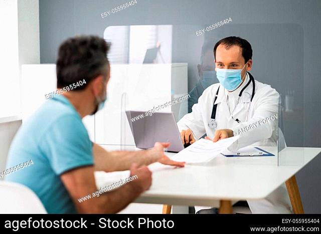 Elder Patient In Doctor Office Or Hospital With Sneeze Guard Screen And Mask
