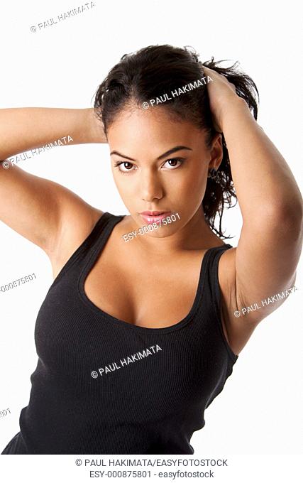 Beautiful Hispanic woman with tanned skin holding pulling up long black hair wearing tank top, isolated