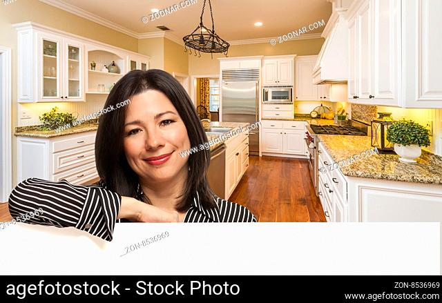 Hispanic Woman Leaning Against White Board In Custom Kitchen Interior