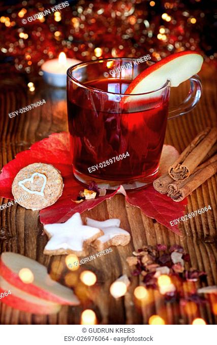 mulled wine with christmas cookies and spices on a christmas market