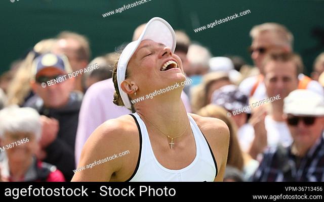 Belgian Yanina Wickmayer celebrates after winning a first round game in the women's singles tournament against Chinese Zhu (WTA 98) at the 2022 Wimbledon grand...