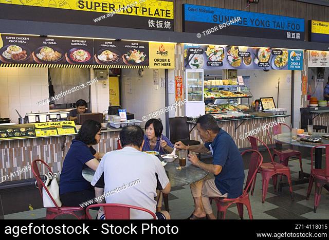 Malaysia, Penang, Georgetown, food court, people, eating. In Georgetown, Penang, Malaysia, you can find a plethora of food courts packed with people enjoying...