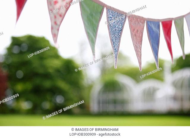 England, West Midlands, Edgbaston, Bunting hanging above a picnic in The Birmingham Botanical Gardens & Glasshouses