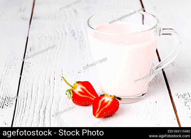 Fresh ripe strawberry with milk in glass