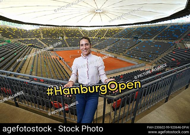 02 June 2023, Hamburg: Andrea Petkovic, former professional tennis player and tournament ambassador, holds up the words ""#HamburgOpen"" in the Rothenbaum...