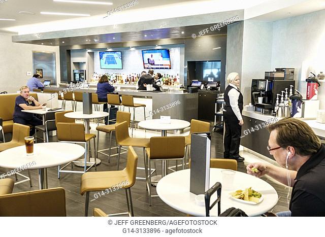 Florida, Miami, International Airport MIA, terminal concourse gate area, American Airlines business class Flagship lounge, dining room, bar, man, woman