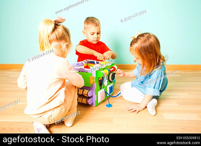Amazing entertaining and developing imagination toy - busy cube and three adorable kids playing with it for the first time
