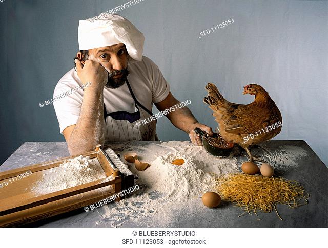 A chef waiting with a chicken