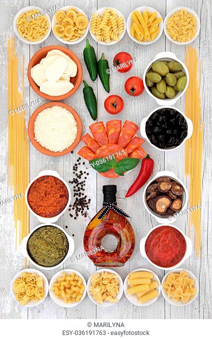 Mediterranean healthy diet food selection with dried pasta and fresh ingredients over distressed white wood background