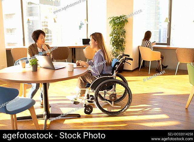 Young woman in wheelchair having one to one lesson
