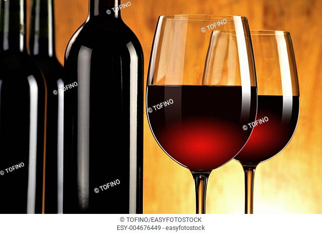 Composition with two wineglasses and bottles of red wine