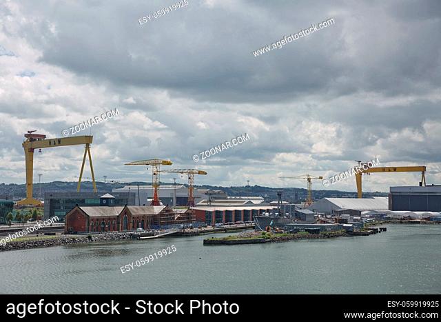 Belfast, Ireland - June 9, 2017: Large industrial cranes loading container ship in Belfast Port in Ireland
