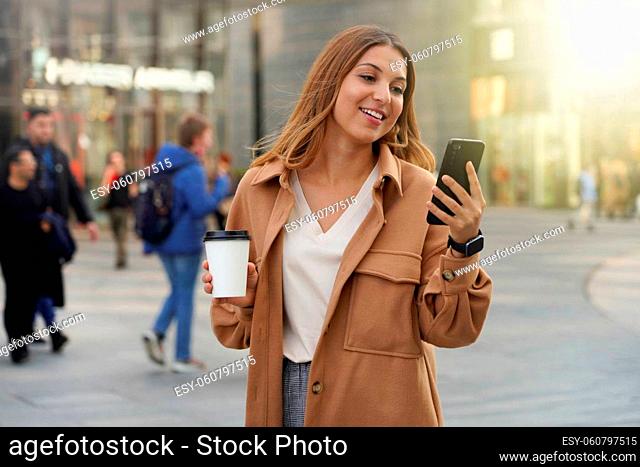 Young business people. Smartphone using. Take away coffee. Smart watch. Black friday shopping. Christmas. Blurred people background