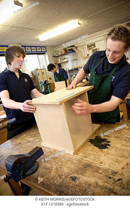 pupils making bookcase from MDF in DT design technology class, secondary school, Wales UK