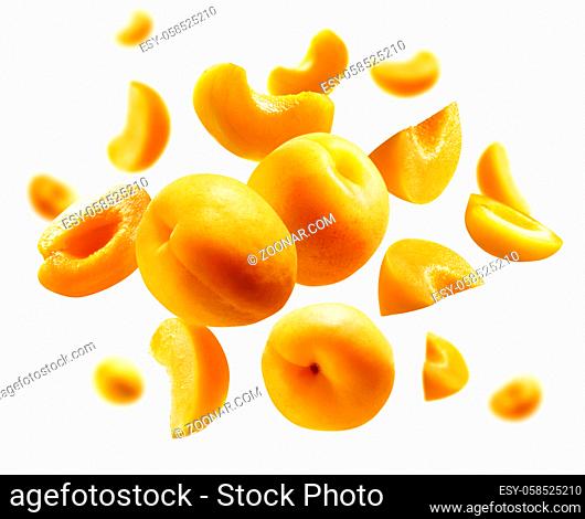 Apricots levitate on a white background. Ripe fruit in flight