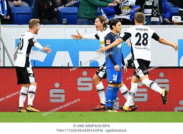 Gladbach's Jannik Vestergaard (c) celebrates after his goal for 1:3 with Nico Elvedi (l) and Matthias Ginter (r) during the Bundesliga soccer match between 1899...