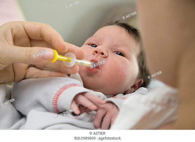 Photo essay at the maternity of Saint-Vincent de Paul hospital, Lille, France. Administration of vitamin D to a newborn baby girl