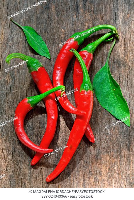 Red Chili Peppers over wooden background