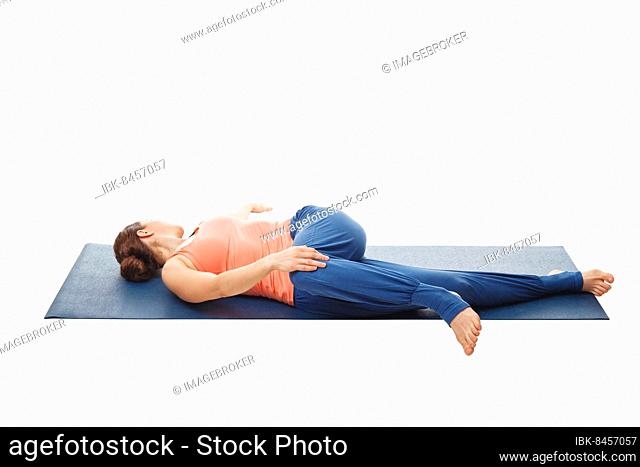 Woman doing Yoga asana Parivrtta ardha pawanmuktasana, Revolved knee-to-chest Pose back stretch isolated on white background