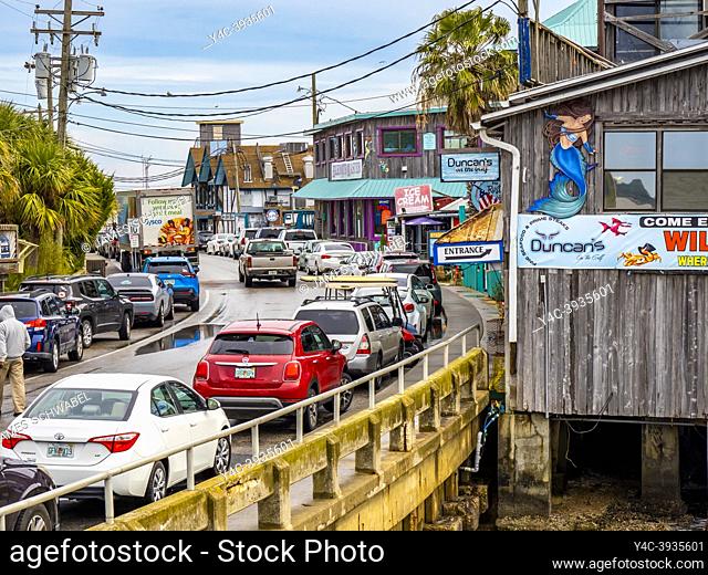 Dock Street restaurants and shops on stilts over water on in Cedar Key Florida USA