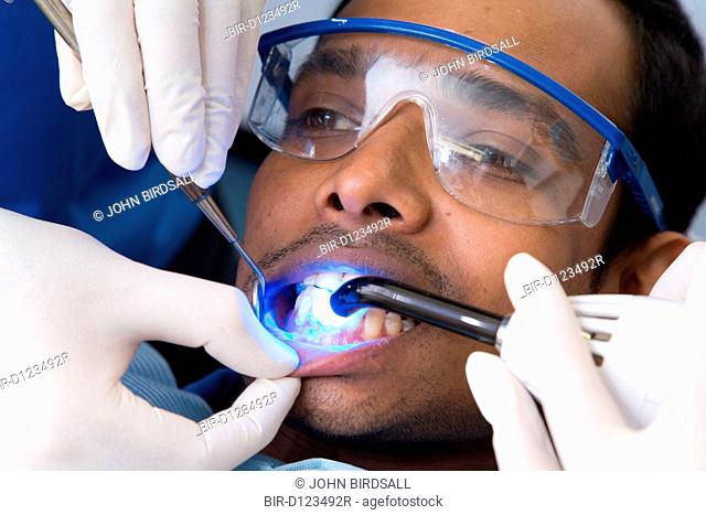 Patient being exposed to ultraviolet light during dental treatment