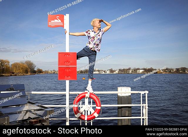 24 February 2021, Hamburg: Jendrik Sigwart, singer and musical performer, stands on a railing during a photo session at the Alster
