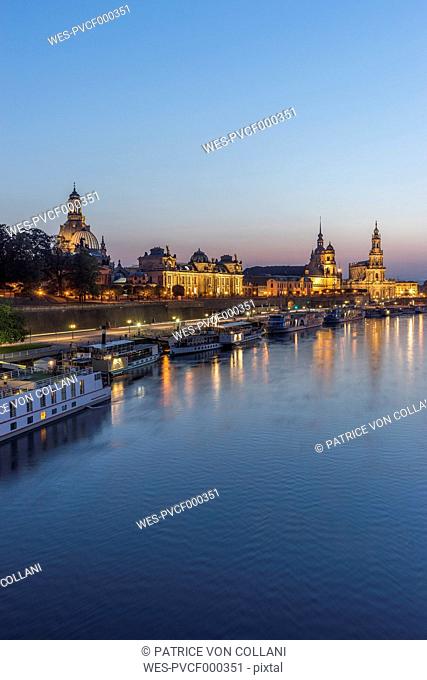 Germany, Dresden, view to lighted old city with Elbe River in the foreground in the evening