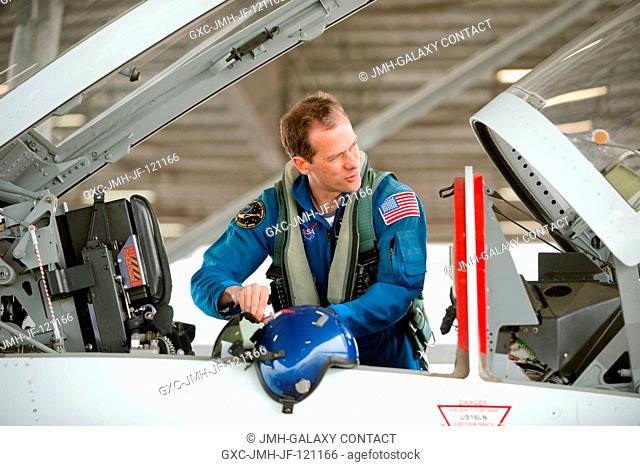 NASA astronaut Tom Marshburn, Expedition 3435 flight engineer, prepares for a flight in a NASA T-38 trainer jet with NASA pilot Thomas Parent (out of frame) at...