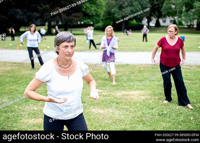 27 June 2020, Lower Saxony, Hanover: Anne Prenzler from Hannover takes part in a TaiChi exercise in the Maschpark. The TaiChi and Qigong day originally planned...