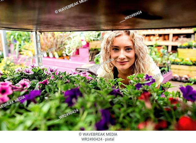 Smiling female florist in garden center