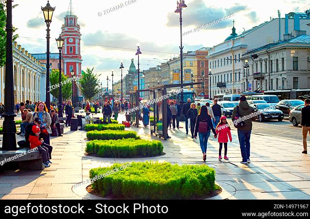 SAINT-PETERSBURG, RUSSIA - JULY 11, 2019: People walking by Gostiny dvor in evening sunlight, cars in traffic jam and sunset cityscape with classical...