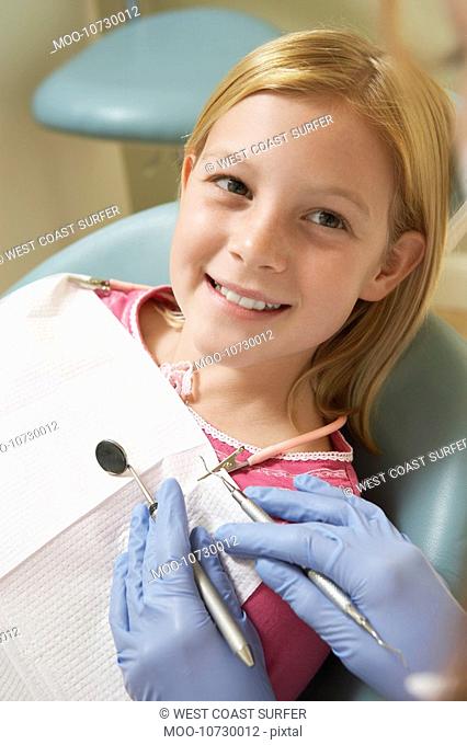 Girl 7-10 at dentists close-up