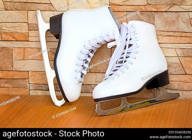 The skates and graceful boots of white color for figure skating on ice for women
