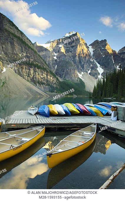 Colorful canoes on dock of Moraine Lake, Banff National Park Alberta Canada