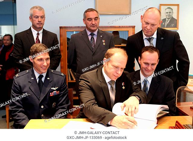 At the Gagarin Cosmonaut Training Center in Star City, Russia, Expedition 3738 Soyuz Commander Oleg Kotov (front row, center) signs a certification book in a...