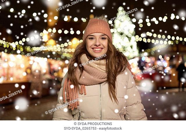happy young woman at christmas market in winter