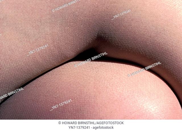 close up abstract view of a woman's crossed legs in pantyhose