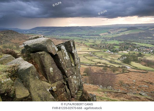 View of upland habitat and gritstone edge with approaching storm, Curbar Edge, Peak District, Derbyshire, England, march