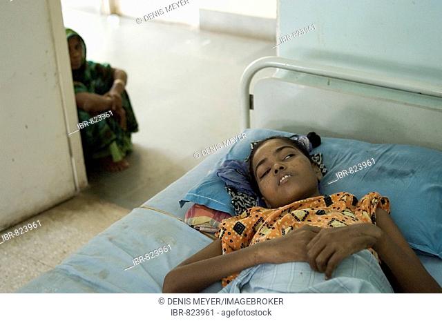 Girl, patient in the private Shree Jain Hospital, her stay funded by an aid organisation, critically ill with tuberculor meningitis, behind her mother, Howrah
