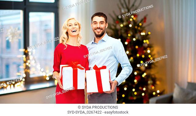 happy couple with christmas gifts at home