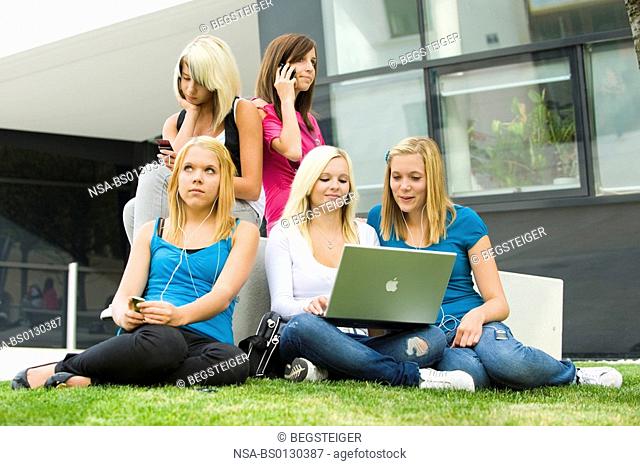 teenager using laptop, Ipod and mobile phone