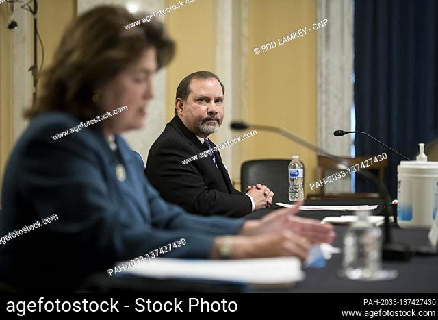 Danny Vargas, Chairman, Friends Of The National Museum Of The American Latino, right, looks on as Jane Abraham, Former Chair